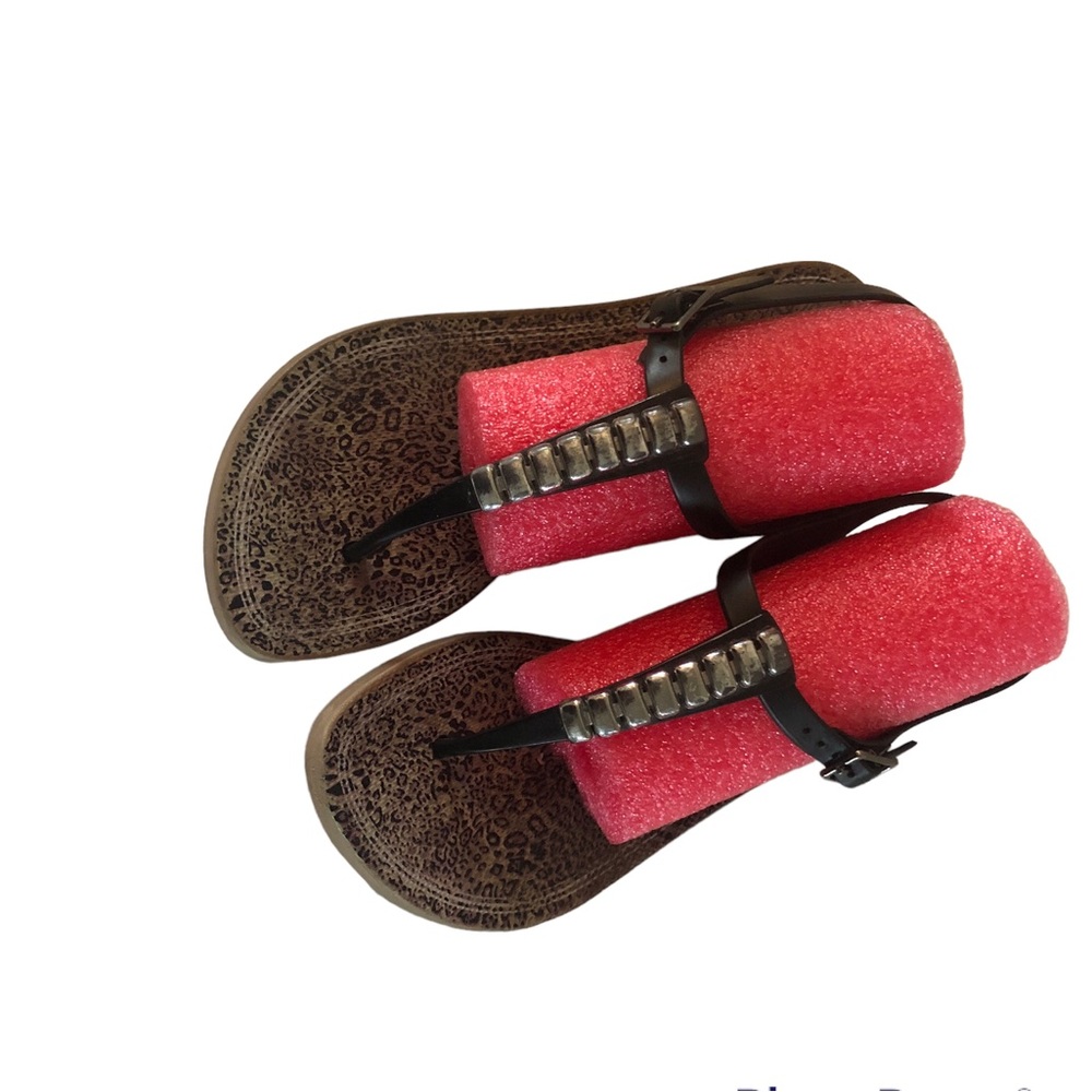 Grendha black thong flat sandals with silver hardware.